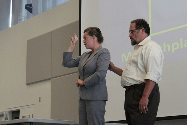 Jelica Nuccio, the first deaf-blind director of the Seattle Deaf-Blind Service Center, (right) gives the keynote address at the 2012 Barriers Summit.